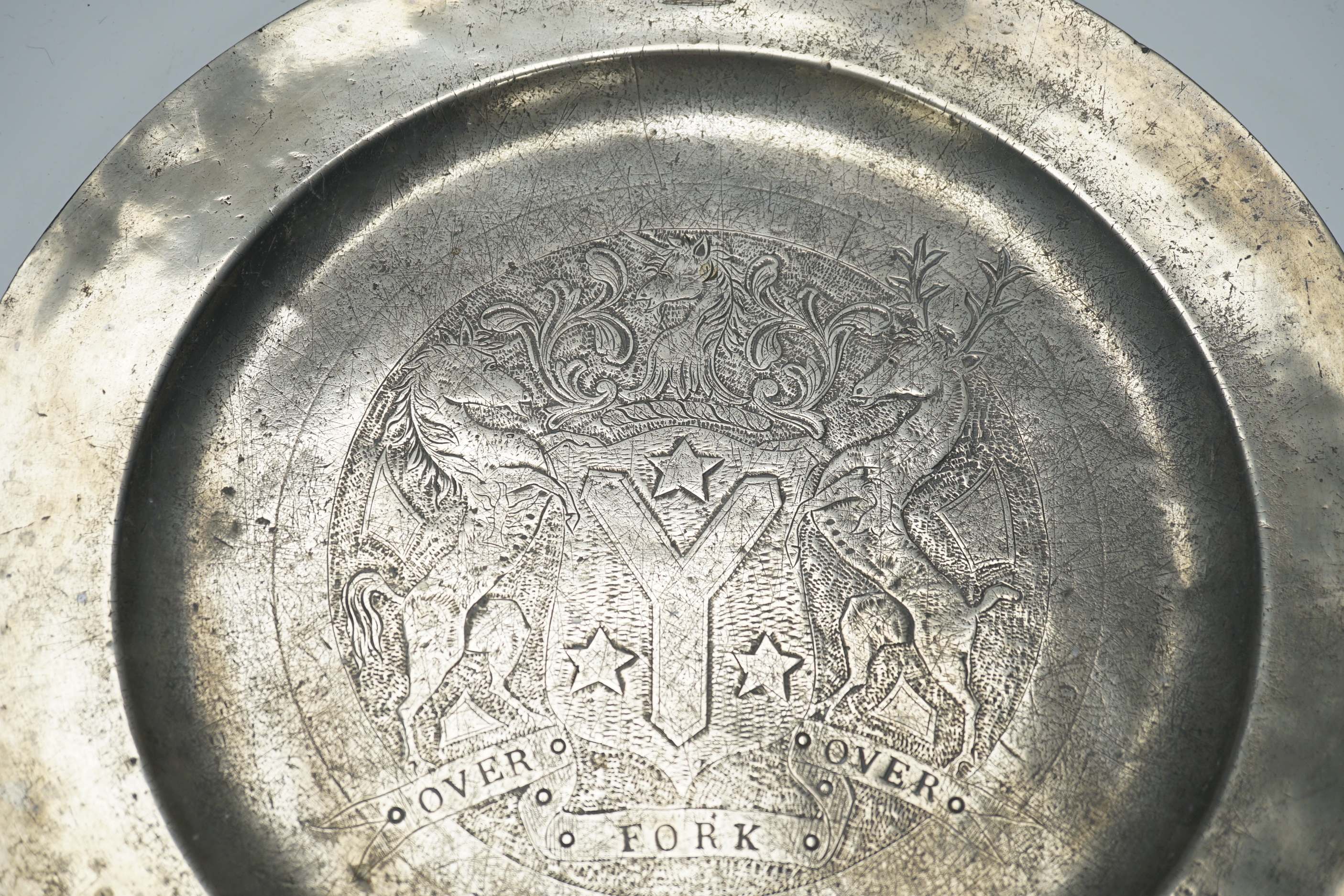 An 18th century pewter armorial charger, 38cm diameter